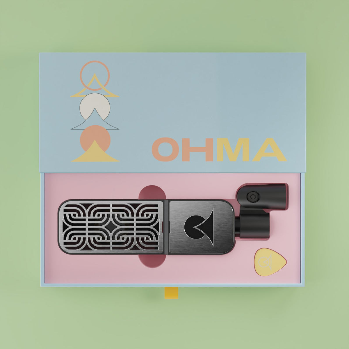 An Ohma mic in its open drawer box with the isolation clip and a pick