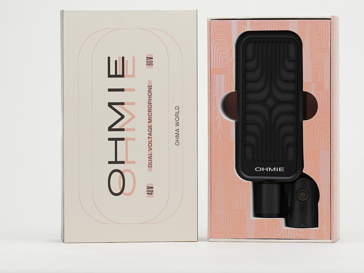 The Ohmie in its isolation clip, sitting in its box next to the box sleeve